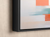 a painting hanging on a wall with a black frame