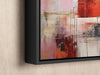 a painting hanging on a wall with a black frame