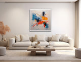 a living room with a white couch and a painting on the wall