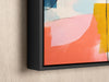 a painting hanging on a wall with a black frame