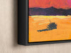 a painting hanging on a wall of a desert