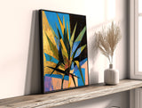 a painting on a shelf next to a vase with a plant